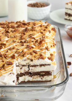 a cake that has been cut into pieces and is sitting on a table next to other desserts