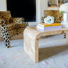 a living room with leopard print chairs and a coffee table