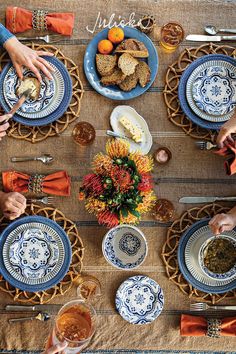 people sitting at a table with plates and food