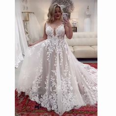 a woman is taking a selfie in her wedding dress while standing on a rug