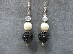 Here is a unique and elegant pair of earrings.  These earrings are elegant enough for evening but would also enhance a casual outfit.  The earrings consist of a black shamballa bead, medium white glass pearl and smaller clear AB crystal with a black rhinestone spacer.  They are finished with silver tone findings and silver tone earwires to complete the look and silicone stops are provided to prevent loss.  From the top of the earwire to the bottom is approximatelu 2 1/4".  The earrings in photo are the exact pair your will receive.    Designed and handcrafted by me for you in my smoke free studio.   No returns accepted but please notify me should there be a problem with your order. Carefully packaged and shipped in a  white box enclosed in bubble envelope.  Shipping is USPS First Class Pac Black Pearl Drop Earrings For Formal Occasions, Black Pearl Drop Earrings For Formal Events, Elegant Black Pearl Earrings, Black Pearl Drop Earrings For Party, Black Pearl Drop Earrings For Evening, Black Beads Drop Earrings For Evening, Black Dangle Pearl Earrings For Formal Occasions, Black Beaded Drop Earrings For Evening, Elegant Round Beads Crystal Earrings For Party