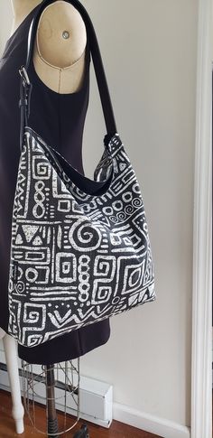 Take this bag with you where ever you go this season. Beautiful shoulder tote / hobo tote bag / bucket tote. Adjustable Vegan leather strap with metal buckle. Black and white African print cotton canvas. Lining is made with sturdy cotton canvas. Large inside pocket for your phone, keys etc. Open top bag but deep enough to keep your valuables safe SMALL SIZE Width: 14 inches Height 13 inches Bottom depth 4 inches Adjustable shoulder strap. Made locally in Newark NJ Hand wash/ line dry Boho Punk, Black And White Bags, Bucket Tote Bag, Slouchy Tote, African Mudcloth, Hobo Tote Bag, Grocery Tote Bag, Newark Nj, Bucket Tote