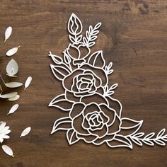 a cutout of flowers on a wooden table