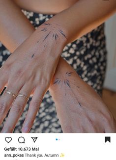 a woman's arm with tattoos on it and her hand holding the other arm