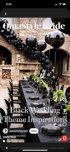 black wedding theme with balloons and greenery on the table in front of an old brick building