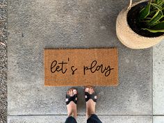 a person standing in front of a door mat that says bet's ready