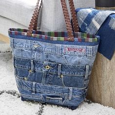 a blue jean purse sitting on top of a white rug