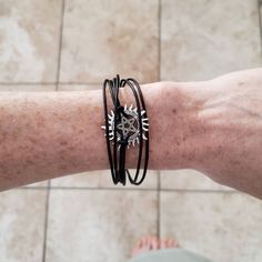 "Protect yourself with a supernatural bracelet. Adorned with an anti possession pentacle and layers of black leather or faux vegan leather. They close with a strong magnetic clasp for easy on and off -but security knowing it will stay put. Those that hunt together, stay together. Keep those evil spirits from inhabiting your body. Makes a perfect gift for your friendly fellow ghost hunters. - Silver tone Anti-possession charm - Made to order in your perfect size 6-9\" inches - Genuine leather OR Symbolic Black Metal Bracelets, Black Symbolic Metal Bracelet, Symbolic Black Metal Bracelet, Gothic Silver Metal Leather Bracelet, Supernatural Bracelet, Protection Sigil, Supernatural Jewelry, Pentacle Jewelry, Supernatural Cosplay