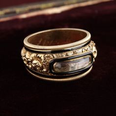 An ornate, strikingly beautiful Georgian mourning ring dedicated to the memory of Thomas Latham. Latham was born in Middlesex, England and died in Surrey after having married twice and fathered a total of 16(!) children. The ring is in near immaculate condition with a foliate design rendered in high relief, reeded edges and an oblong hair locket framed in black enamel. The interior of the ring is engraved: "Thomas Lathan died 13 Aug 1818 Aged 75." Hair Locket, Remembrance Jewelry, High Relief, Men's Rings, Rock Crystal, Black Enamel, Hair Jewelry, Locket, Rings For Men