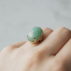 This ring is sure to be the apple of your eye. Set in 14k yellow gold, at the center sits a large piece of apple mottle jade. The granny smith color of the cabochon cut gemstone is a wonderful neutral for your everyday look. Modern Oval Jade Ring, Estate Wedding Ring, Estate Rings, Gem Diamonds, Contemporary Ring, Granny Smith, Jade Ring, Stone Cuts, Custom Engagement Ring