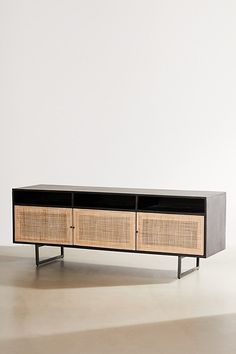 the sideboard is made out of rattan and has two drawers on each side