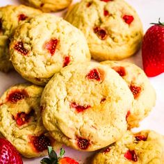 several cookies and strawberries on a white plate