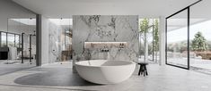 a large white bath tub sitting inside of a bathroom next to a tall glass wall