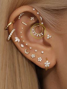 the ear is decorated with jewels and gold colored metal pieces, which are attached to each side of the ear