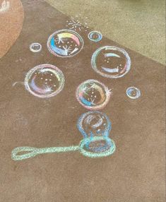 the sidewalk has been drawn with colored pencils and water bubbles on it, as well as a key