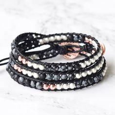 A gorgeous mix of snowflake jasper, bright silver matte hematite, and rose gold hematite on black leather. A perfect 3x wrap bracelet for all seasons. 4mm (.157") diameter mixed stone beads Antique copper button closure, 16mm (.67") diameter Soft black leather Signature Bluefish logo heart charm 51 - 56 cm/20 - 22" length 3 button loop adjustments to fit most wrists Nickel, lead, and cadmium free Limited edition Gift ready Adjustable Silver Wrap Bracelet With Gemstone Beads, Black Spiritual Wrap Bracelet With Round Beads, Adjustable Black Wrap Bracelet Hand-strung, Adjustable Black Wrap Bracelet With Round Beads, Black Adjustable Spiritual Wrap Bracelet, Adjustable Black Hand Wrapped Wrap Bracelet, Adjustable Hand Wrapped Black Wrap Bracelet, Logo Heart, Boho Wrap Bracelet