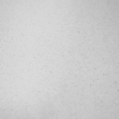 a black and white photo of an airplane in the sky with snow flakes on it