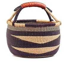 a woven basket with leather handle on the top is shown in black, tan and white stripes