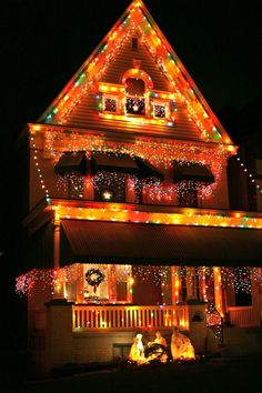 a house covered in christmas lights at night