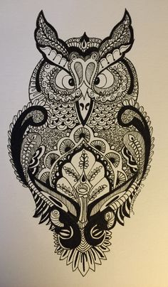 an owl with intricate designs on it's face