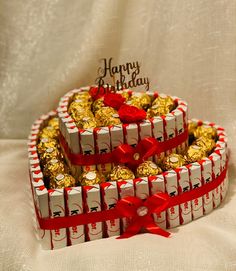 two heart shaped boxes filled with chocolates on top of a table