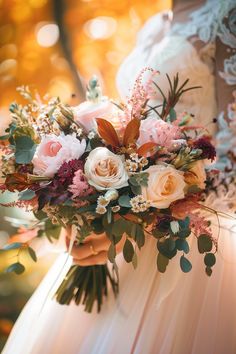 a bride holding a bouquet of flowers in her hands