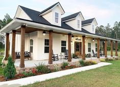 a white house with porches and chairs on the front