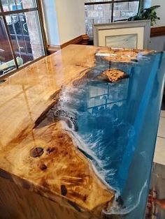 the table is made out of wood and has blue paint on it, as well as an ocean scene