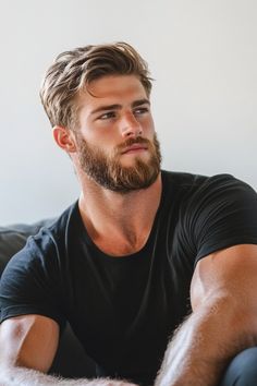 a man with a beard sitting on a couch