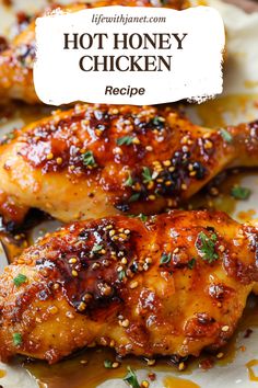 two chicken wings covered in sesame seeds and seasoning on a white plate with the words hot honey chicken recipe