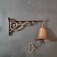 a bell hanging from the side of a wall