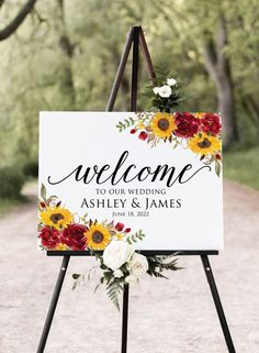 a welcome sign with sunflowers and roses on it