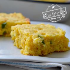 two pieces of cornbread on a white plate