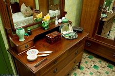 an antique dresser with mirror and other items on it