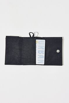 BAGGU snap wallet. This handy trifold wallet from BAGGU features a webbing loop so you can clip it to your keychain, with four card pockets, one bill fold and a snap closure. Made of recycled heavyweight nylon body with recycled ripstop nylon exterior. Features BAGGU nylon wallet Tri-fold design Made with recycled materials Hook & loop closure Content + Care 100% Recycled nylon Machine wash Imported Size Dimensions: 4" l x 3" h | BAGGU Snap Wallet in Black, Women's at Urban Outfitters Functional Wallet With Key Clip For Daily Use, Everyday Functional Wallets With Key Clip, Everyday Functional Wallet With Key Clip, Versatile Trifold Wallet With Rfid Blocking For Everyday, Versatile Trifold Wallet With Rfid Blocking, Functional Trifold Wallet With Rfid Blocking For Daily Use, Functional Trifold Wallets With Card Slots, Black Trifold Wallet For Everyday Use, Black Trifold Wallet For Everyday