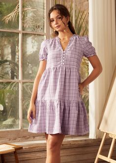 Imagine a field of lavender under a pristine sky – that's the spirit captured by this checkered, purple babydoll dress from our ModCloth namesake label. Soft, with a flirty V-neck and puff short sleeves, it packs a punch of retro-inspired fun. The mini length adds a playful twist, making it perfect for exploring bookshops or enjoying a weekend getaway. Its light fabric dances around the legs, offering both comfort and a dash of allure to your movements. With this dress, every day is an opportuni Purple Babydoll Dress, Field Of Lavender, Halloween Shoes, Purple Baby, Checkered Dress, Plus Size Coats, Purple Plaid, 1940s Fashion, 1960s Fashion