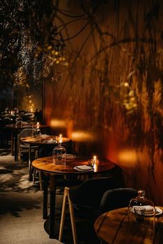 a dimly lit restaurant with tables and chairs