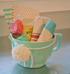 a tea cup filled with lots of different items