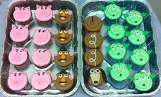 cupcakes decorated like farm animals and pigs in tinfoil trays on a table