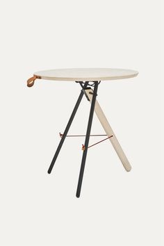 a white table with black legs and an orange handle on it's end, in front of a white background