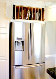 a stainless steel refrigerator in a white kitchen