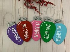 four different colored guitar picks with the words rockin'around them hanging from hooks