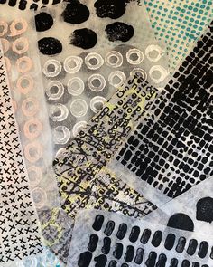 an assortment of black and white paper with circles