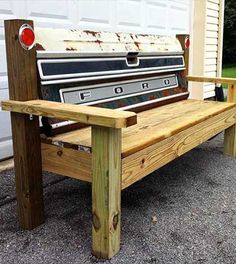 an old wooden bench sitting in front of a garage