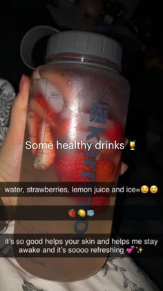 someone holding up a jar with some strawberries in it and the caption reads, some healthy drinks water, strawberries, lemon juice and ices