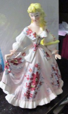 a figurine of a woman in a white dress