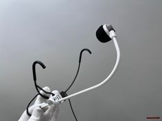 a hand holding a microphone with a cord attached to it