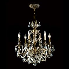 a gold chandelier with crystal drops hanging from it's center and sides