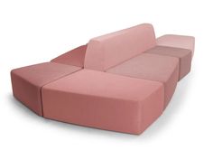 a pink couch sitting on top of a white floor