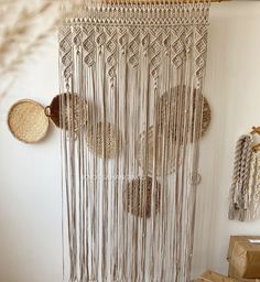 there is a wall hanging made out of macrame beads and other things on the wall